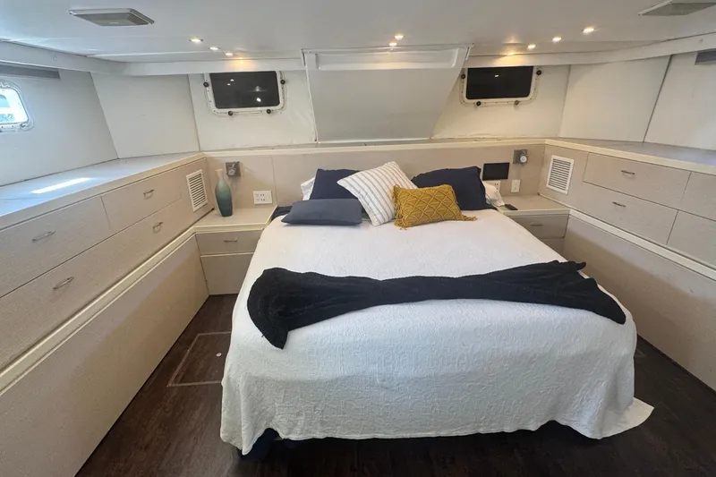 Slide: The Image of Luxurious bedroom interior of 1989 Hatteras 65 Motor Yacht with elegant bedding and ample storage. - 11