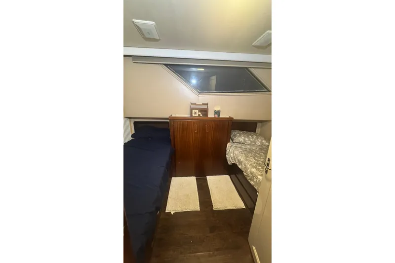 Slide: The Image of Interior cabin of 1989 Hatteras 65 Motor Yacht with twin beds and wooden cabinetry. - 13