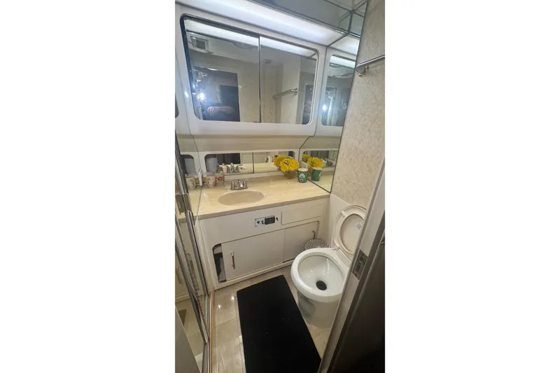 Slide: The Image of Luxurious bathroom in 1989 Hatteras 65 Motor Yacht with modern fixtures and elegant decor. - 15