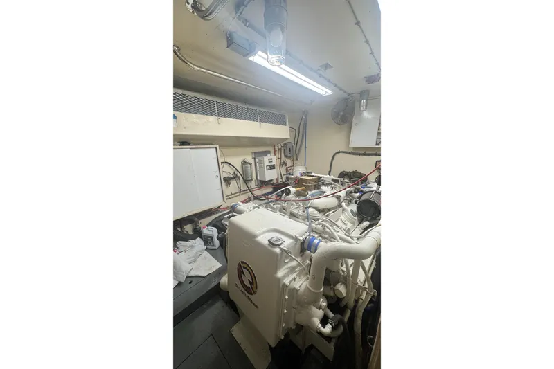 Slide: The Image of Engine room of 1989 Hatteras 65 Motor Yacht with visible machinery and piping. - 16