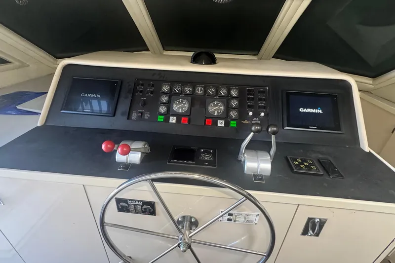 Slide: The Image of Control panel of 1989 Hatteras 65 Motor Yacht with Garmin navigation displays. - 3