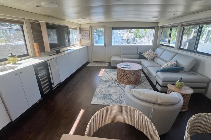 Slide: The Image of Luxurious interior of 1989 Hatteras 65 Motor Yacht with modern furnishings and large windows. - 7