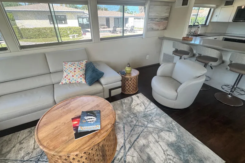 Slide: The Image of Luxurious interior of 1989 Hatteras 65 Motor Yacht with modern seating and decor. - 8