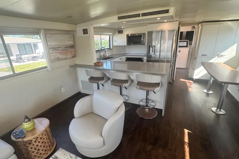 Slide: The Image of Modern interior of 1989 Hatteras 65 Motor Yacht with kitchen and seating area. - 9