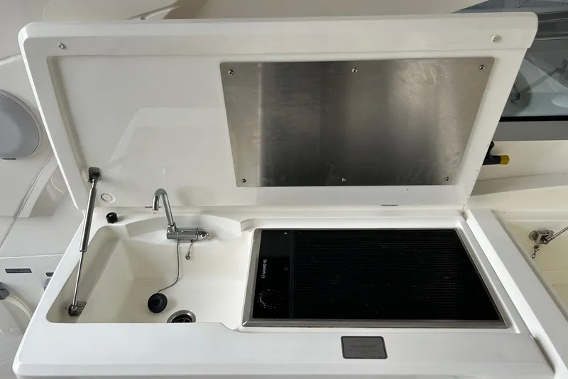 Slide: The Image of 2007 Fairline Targa 47 GT yacht sink and grill area with open lid. - 22