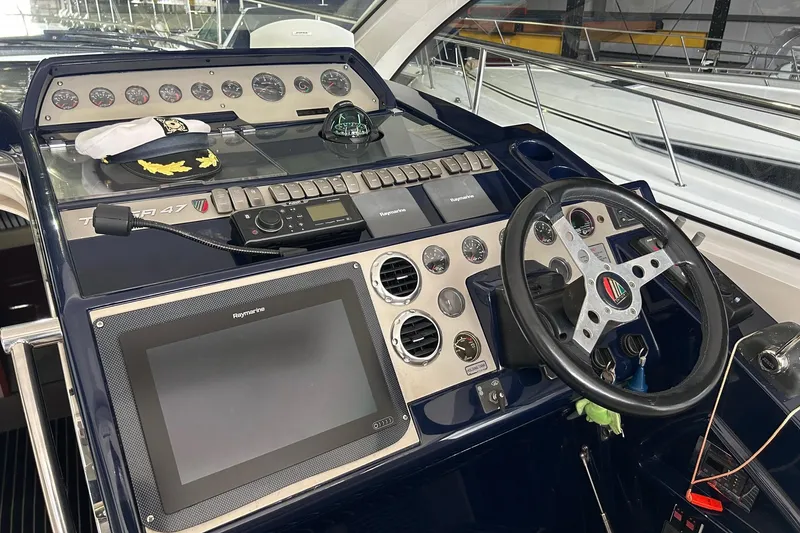 Slide: The Image of Control panel of a 2007 Fairline Targa 47 GT yacht with steering wheel and navigation equipment. - 28