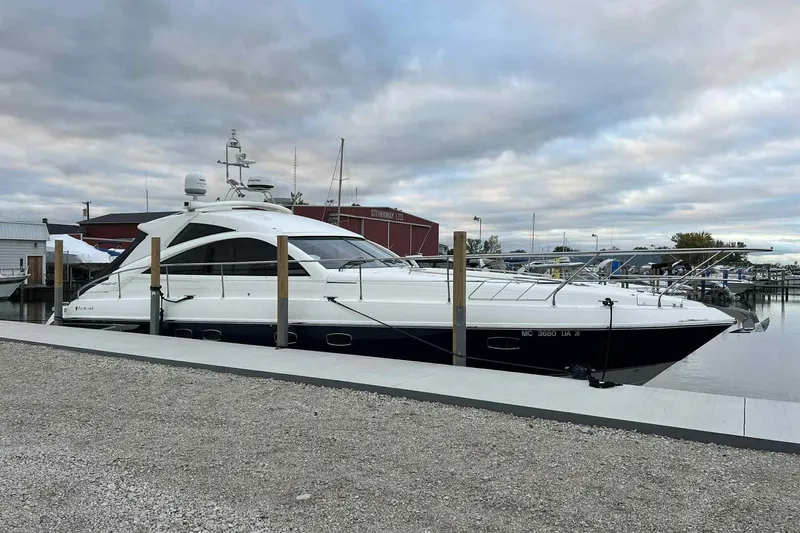 Slide: The Image of 2007 Fairline Targa 47 GT yacht docked at a marina under cloudy skies. - 3
