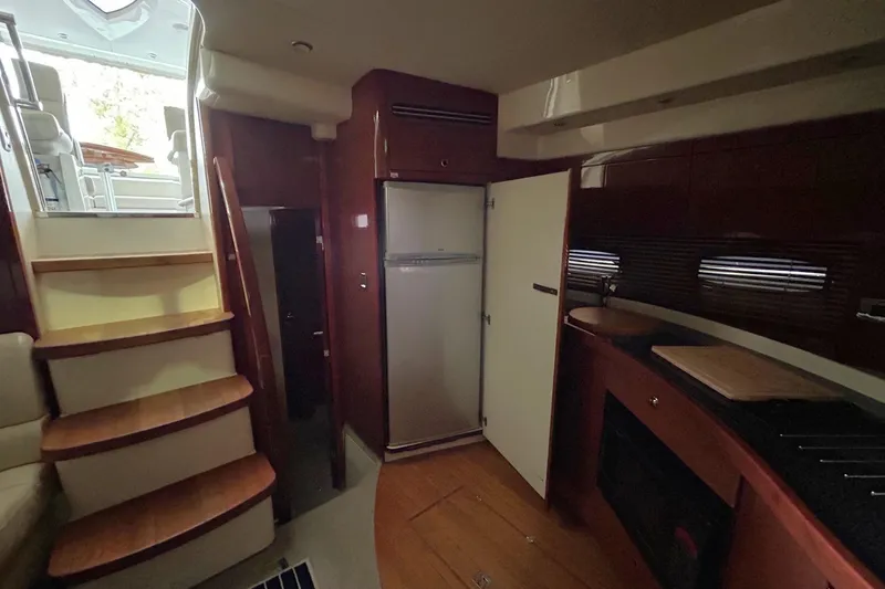 Slide: The Image of Interior of 2007 Fairline Targa 47 GT yacht with stairs, kitchen, and seating area. - 35