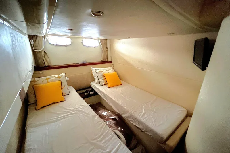Slide: The Image of 2007 Fairline Targa 47 GT cabin with twin beds and yellow accent pillows. - 38