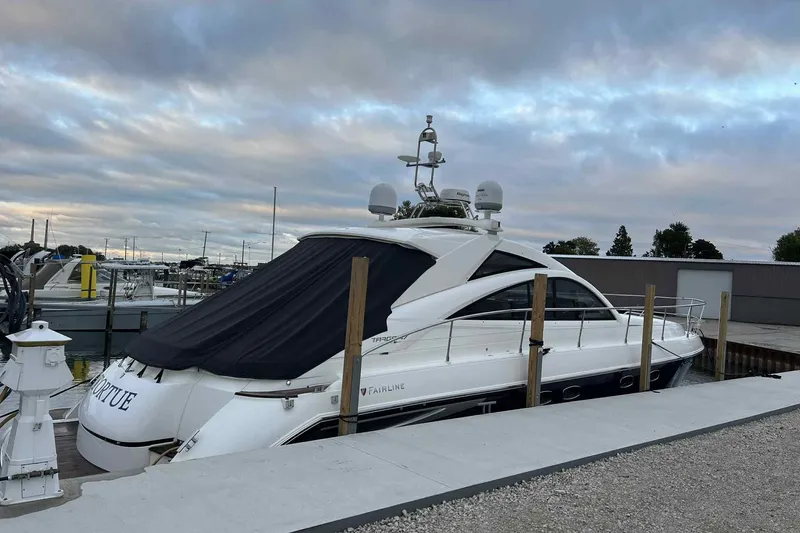 Slide: The Image of 2007 Fairline Targa 47 GT yacht docked at marina under cloudy sky. - 4