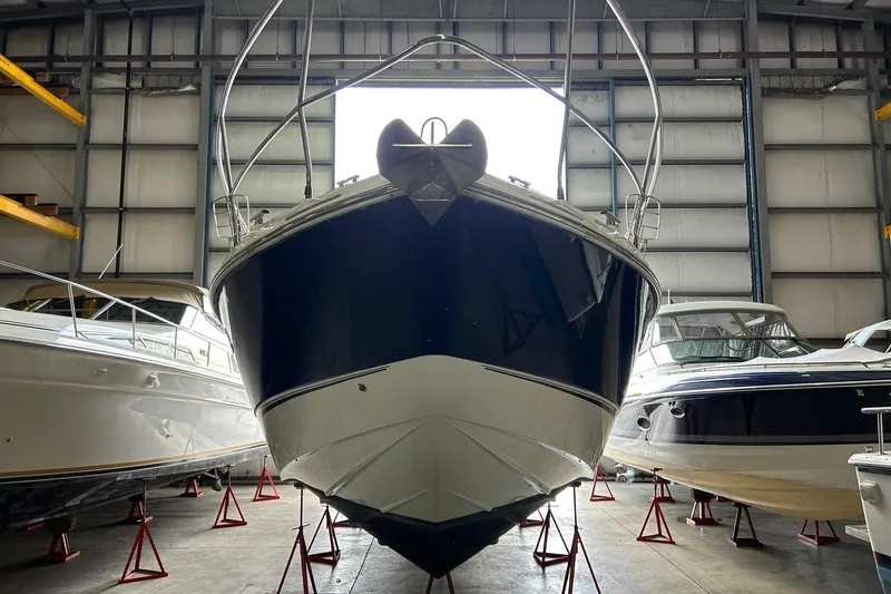 Slide: The Image of 2007 Fairline Targa 47 GT yacht in storage, front view, surrounded by other boats. - 46
