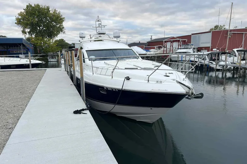 Slide: The Image of 2007 Fairline Targa 47 GT yacht docked at a marina, surrounded by calm waters. - 5