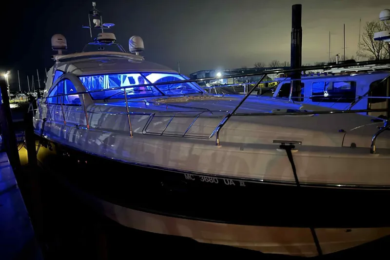Slide: The Image of 2007 Fairline Targa 47 GT yacht illuminated with blue lights at night in a marina. - 6