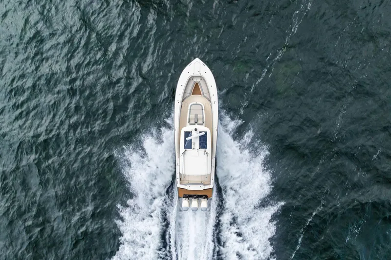 Slide: The Image of Aerial view of 2020 Scout 355 LXF boat cruising on open water. - 14
