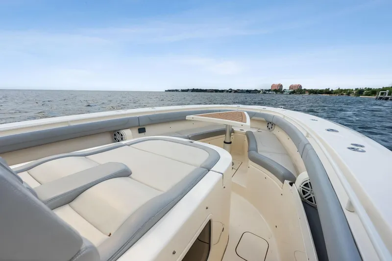 Slide: The Image of 2020 Scout 355 LXF boat interior with luxurious seating on open water. - 15