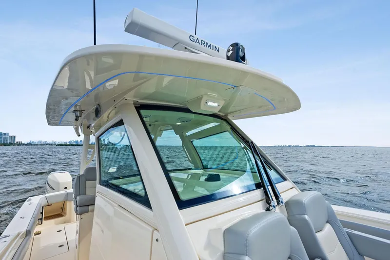 Slide: The Image of 2020 Scout 355 LXF boat on water, featuring Garmin equipment and sleek design. - 19