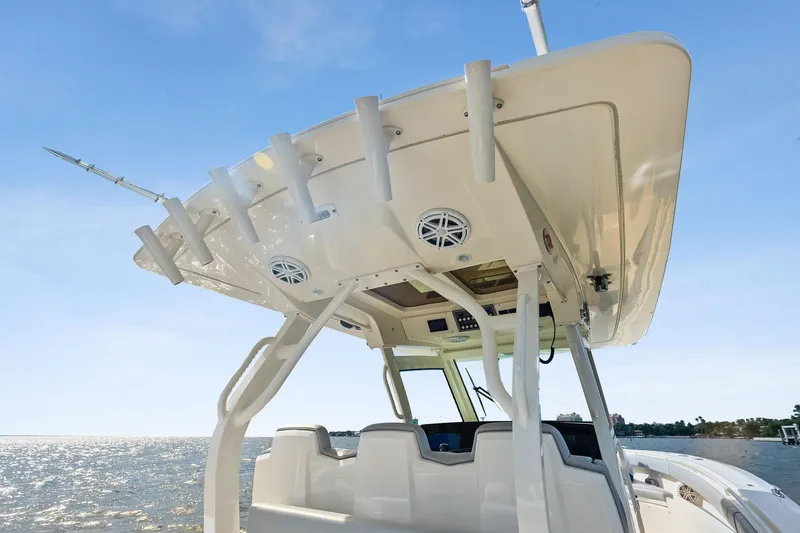 Slide: The Image of 2020 Scout 355 LXF boat with sleek design and modern features on open water. - 31