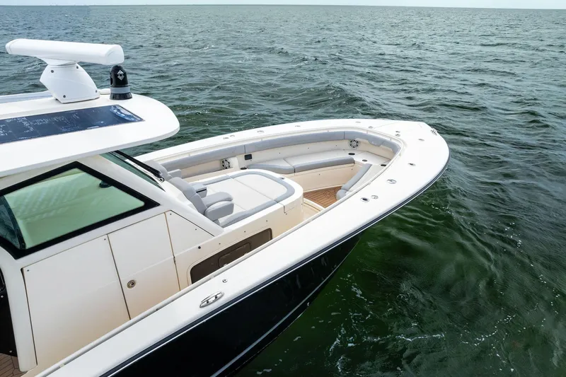Slide: The Image of 2020 Scout 355 LXF boat on open water, showcasing sleek design and spacious seating. - 8