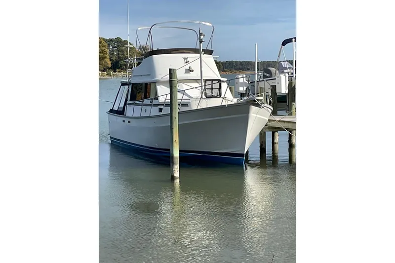 Slide: The Image of 1982 Mainship 34 MK 1 boat docked on calm water. - 1
