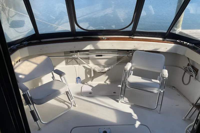 Slide: The Image of 1982 Mainship 34 MK 1 boat interior with two chairs and water view. - 10