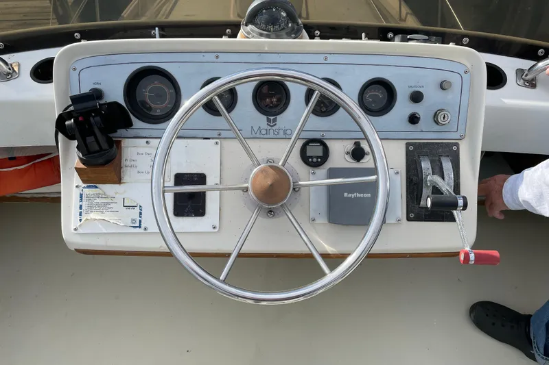 Slide: The Image of 1982 Mainship 34 MK 1 helm with steering wheel, gauges, and controls. - 12