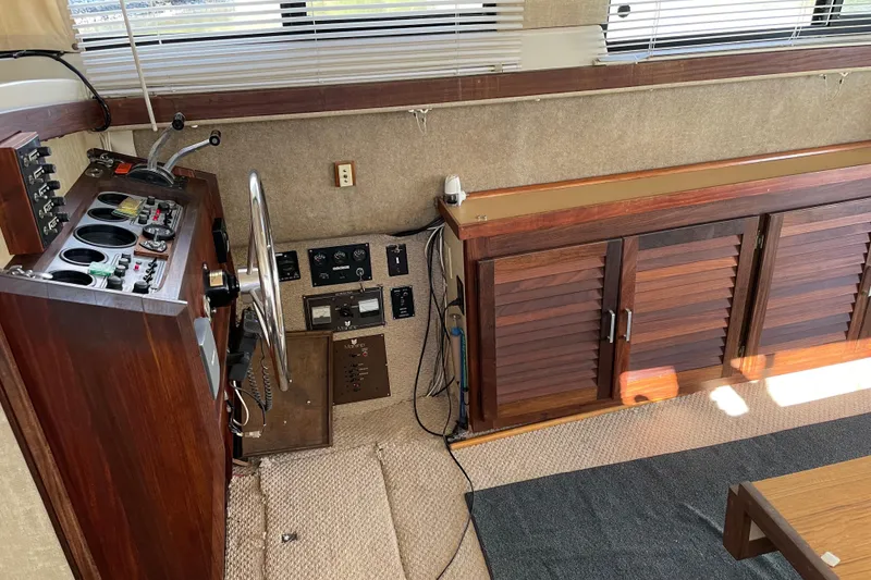 Slide: The Image of Interior of 1982 Mainship 34 MK 1 boat with wooden helm and control panel. - 13