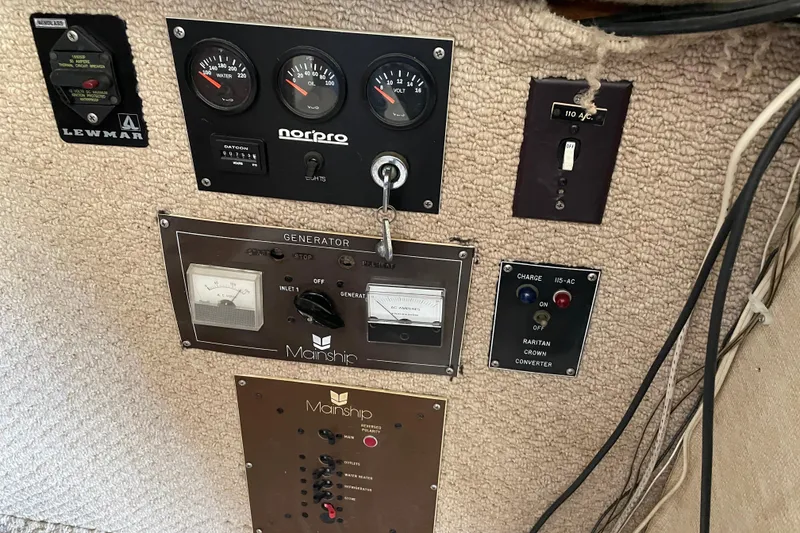 Slide: The Image of Control panel of a 1982 Mainship 34 MK 1 boat with gauges and switches. - 21