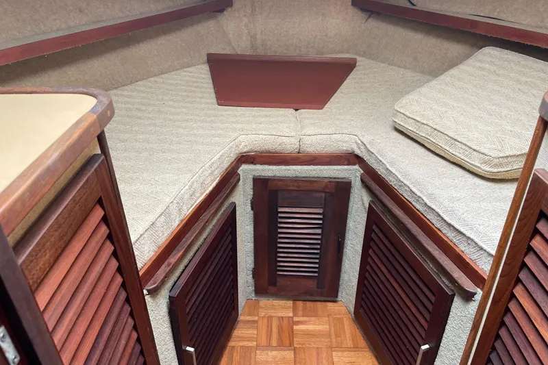 Slide: The Image of Cozy cabin interior of 1982 Mainship 34 MK 1 with wood accents and cushioned seating. - 26