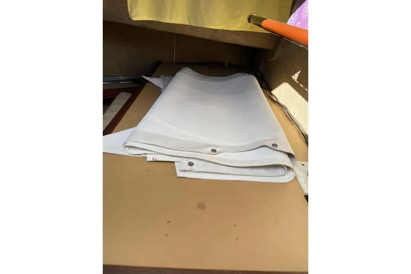 Slide: The Image of Folded white canvas on Mainship 34 MK 1, 1982 boat interior. - 28