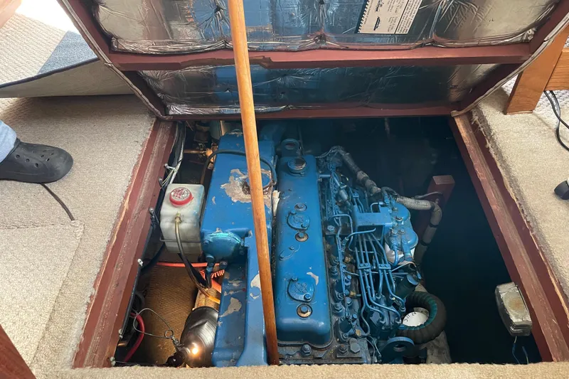 Slide: The Image of Engine compartment of a 1982 Mainship 34 MK 1, showcasing a blue marine engine. - 31