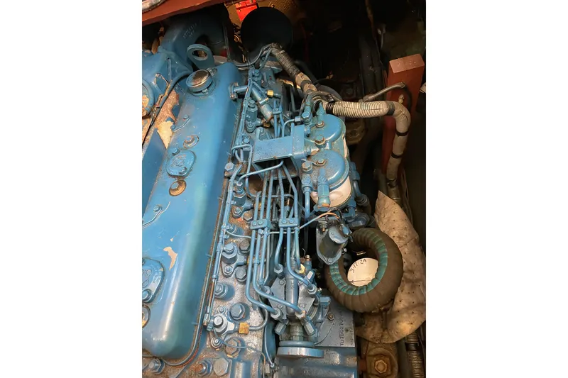 Slide: The Image of Engine of 1982 Mainship 34 MK 1, detailed view with blue components. - 32