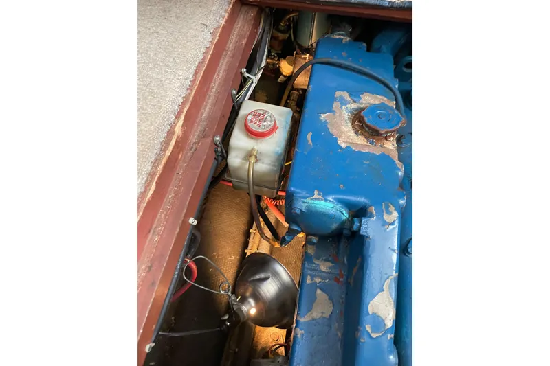 Slide: The Image of 1982 Mainship 34 MK 1 engine compartment with blue engine and maintenance light. - 33