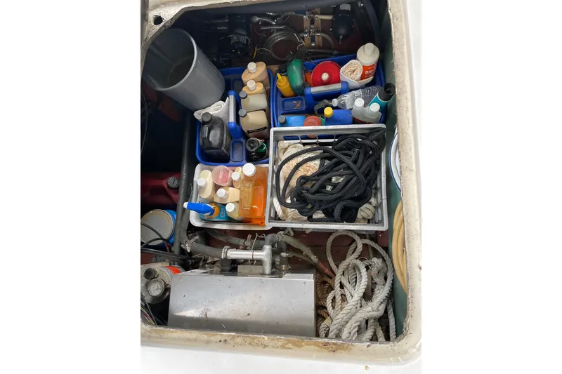 Slide: The Image of Storage compartment of 1982 Mainship 34 MK 1 with ropes and maintenance supplies. - 34