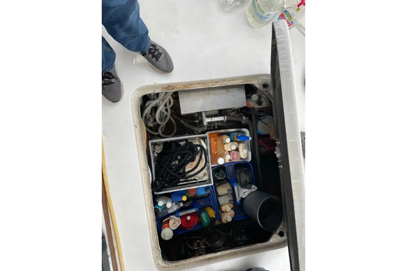 Slide: The Image of Open hatch on 1982 Mainship 34 MK 1 boat showing storage with ropes and supplies. - 35