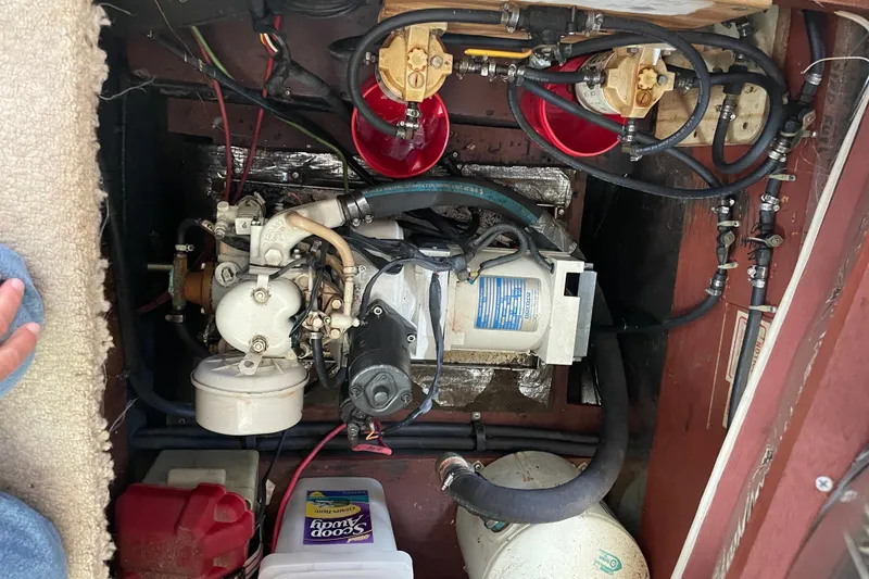 Slide: The Image of Engine compartment of a 1982 Mainship 34 MK 1, showing mechanical components and wiring. - 36