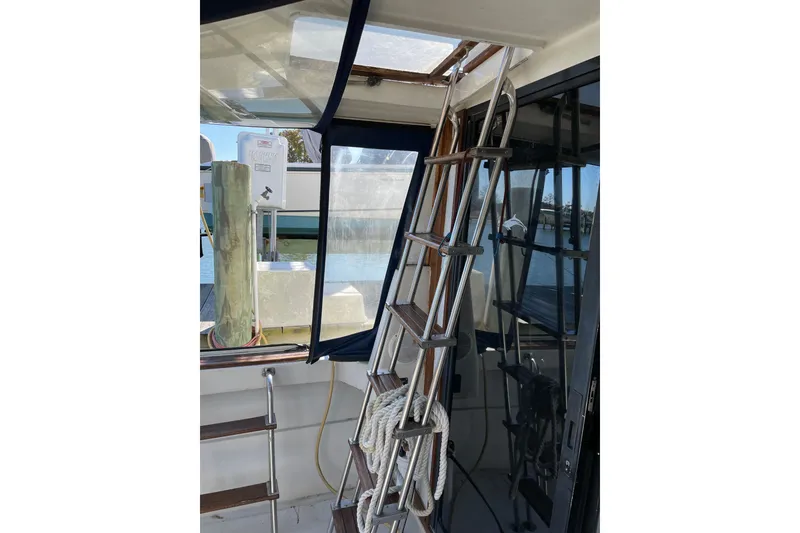 Slide: The Image of Interior view of 1982 Mainship 34 MK 1 boat with ladder and dockside background. - 9