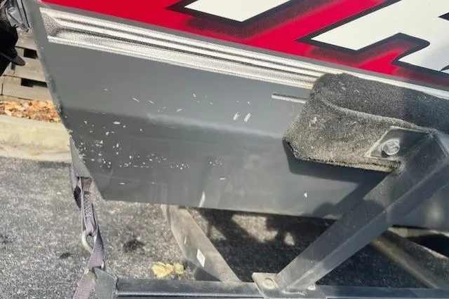 Slide: The Image of 2017 Tracker Pro Team 195 TXW boat on trailer, showing hull details and minor scuffs. - 10