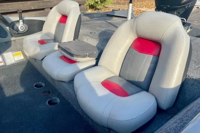 Slide: The Image of 2017 Tracker Pro Team 195 TXW boat seats with red and gray upholstery. - 13