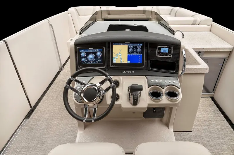 Slide: The Image of 2018 Harris V270 boat with blue exterior and beige interior, docked near greenery. - 1