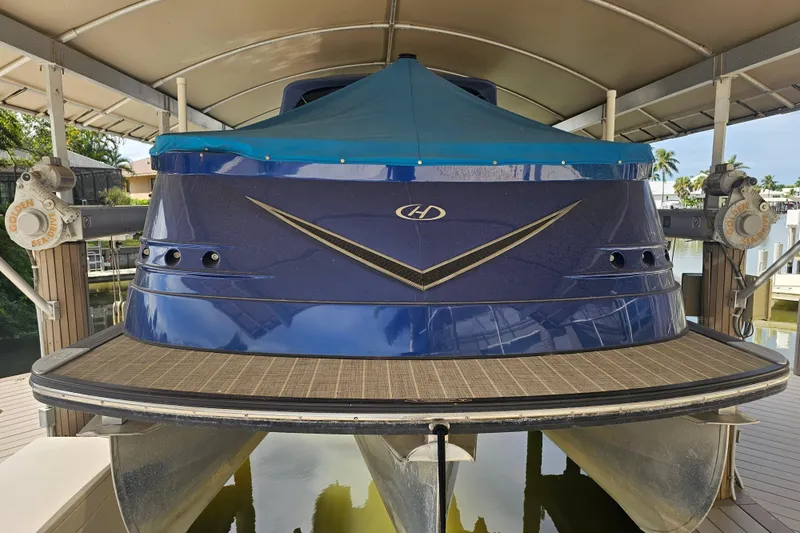 Slide: The Image of 2018 Harris V270 pontoon boat on lift under canopy. - 10