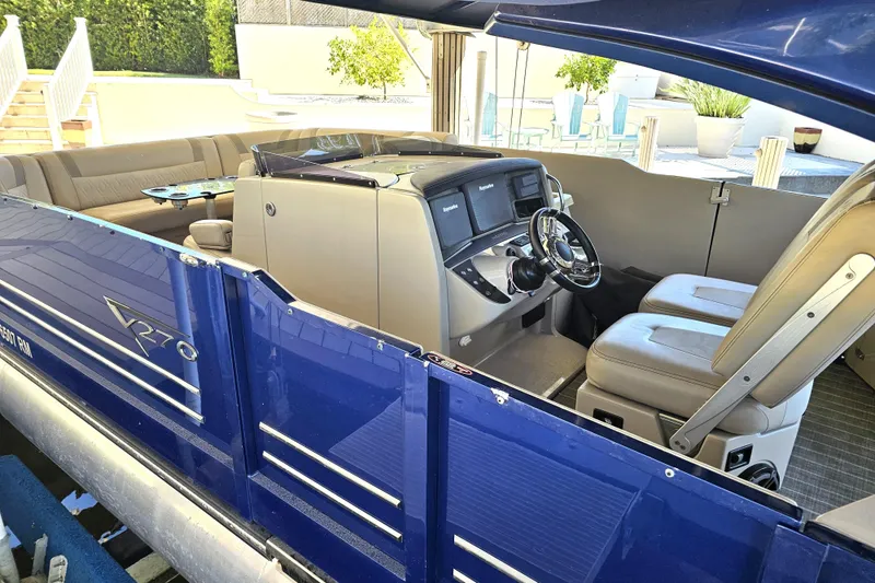 Slide: The Image of 2018 Harris V270 boat with blue exterior and chrome accents. - 17