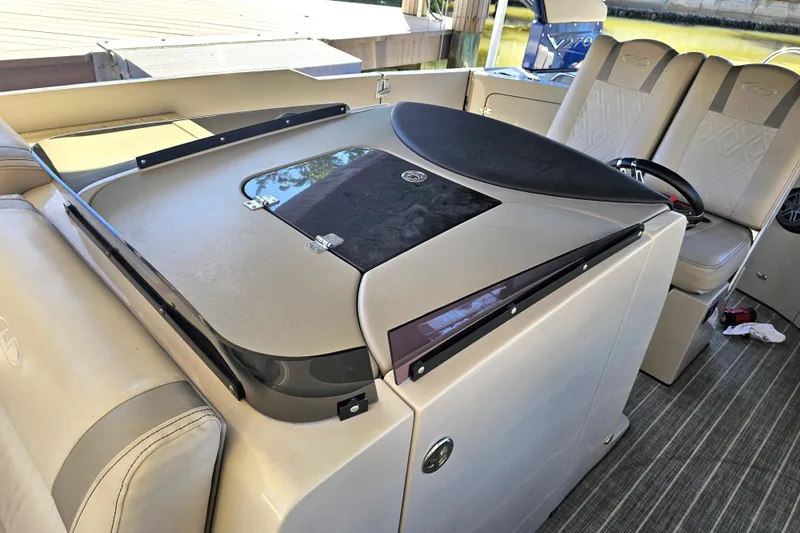 Slide: The Image of Luxurious seating area on a 2018 Harris V270 boat with a sleek table and cup holders. - 21