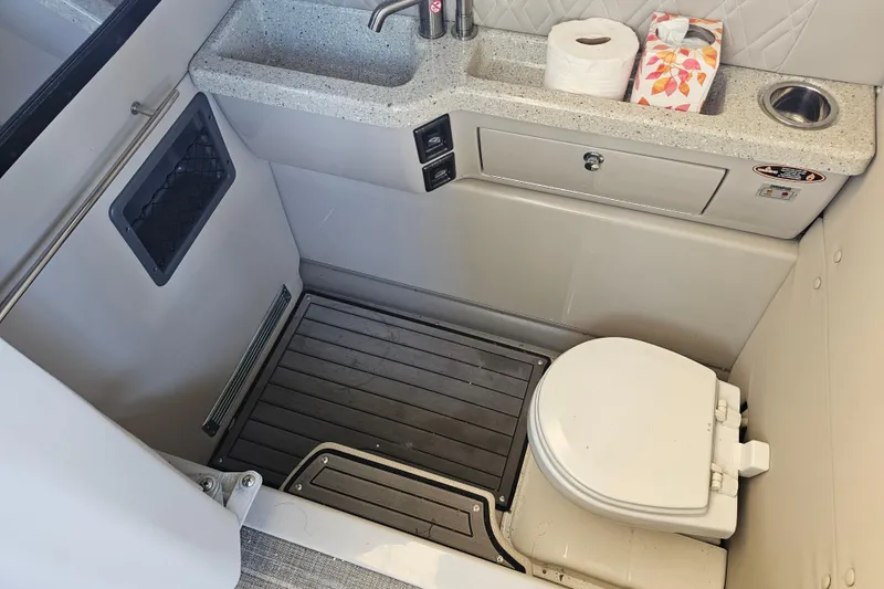 Slide: The Image of 2018 Harris V270 boat interior with steering console and seating area. - 24