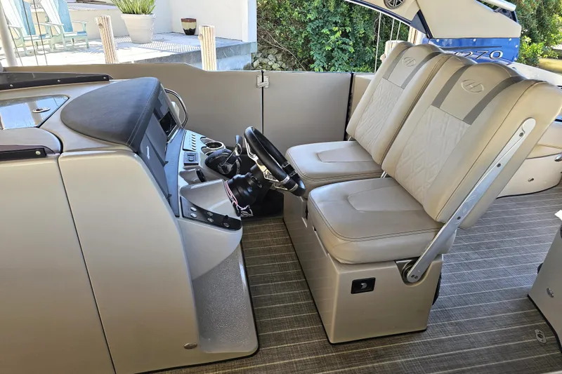 Slide: The Image of 2018 Harris V270 boat interior with compact bathroom, featuring toilet and storage. - 26