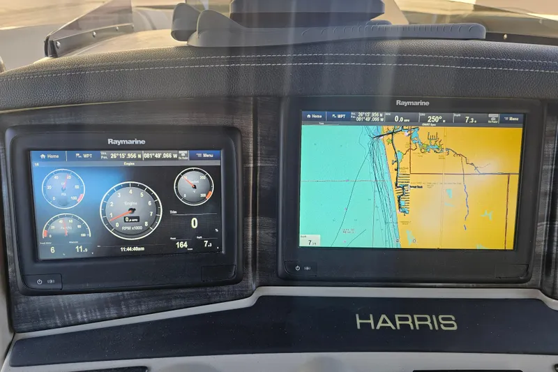 Slide: The Image of 2018 Harris V270 boat dashboard with Raymarine displays and steering wheel. - 28