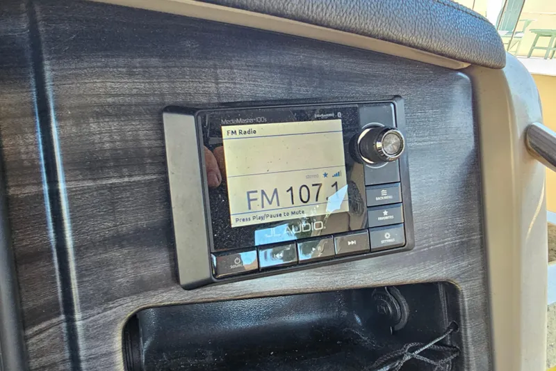 Slide: The Image of 2018 Harris V270 boat interior with dual beige captain seats and modern dashboard. - 29