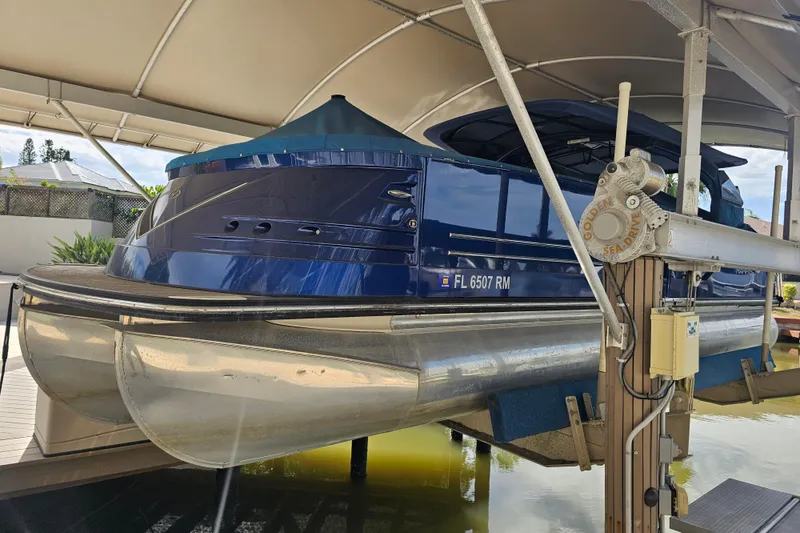 Slide: The Image of Manufacturer Provided Image: 2018 Harris V270 boat with blue canopy and outboard motor. - 7