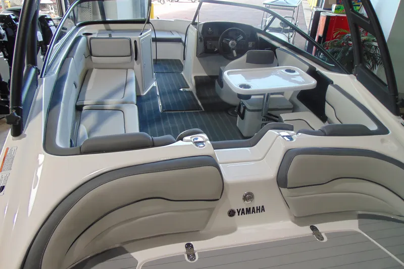 Slide: The Image of 2026 Yamaha Boats AR190 interior with seating, table, and steering wheel. - 7