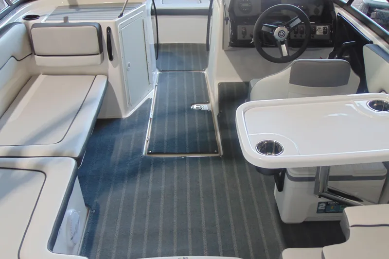 Slide: The Image of 2026 Yamaha Boats AR190 interior with seating, table, and steering console. - 8