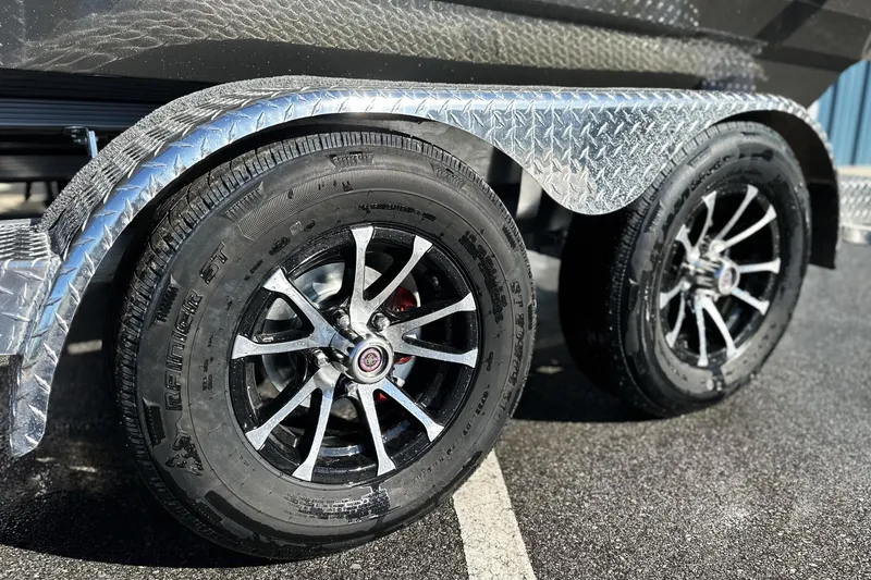 Slide: The Image of Shiny black wheels on 2026 Avid 21 FSX trailer with diamond plate fender. - 11